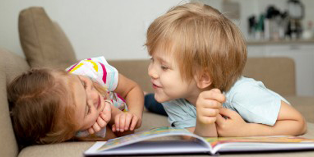 Two toddlers reading a book - Toddler reading
